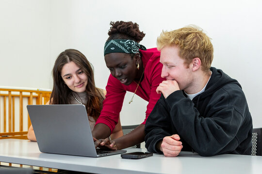Multiethnic student group collaborating on a laptop