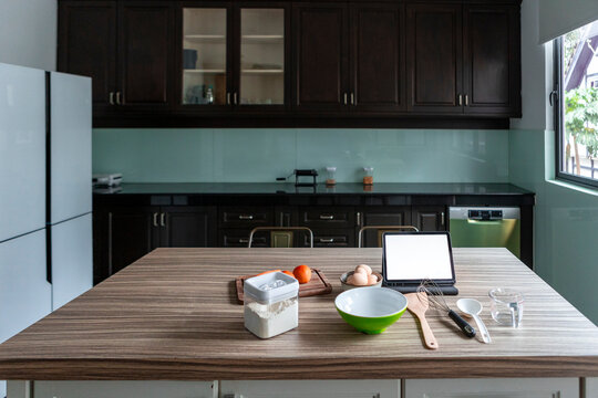 Modern kitchen counter with baking tools and tablet
