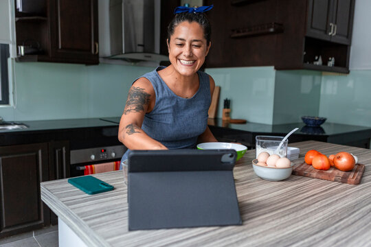Woman making handmade pasta in modern kitchen at home