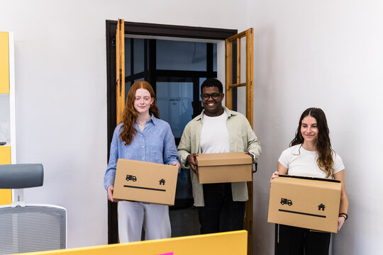Employees carrying boxes during office relocation and move