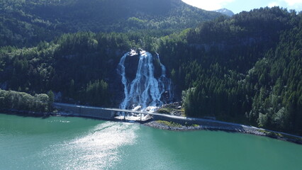 Waterfall flowing into Norwegian fjord © Szymon