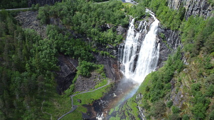 Large waterfall with rainbow viewed from drone in Norway © Szymon