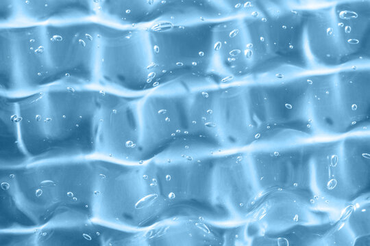 Abstract blue gel texture with bubbles and watery smear