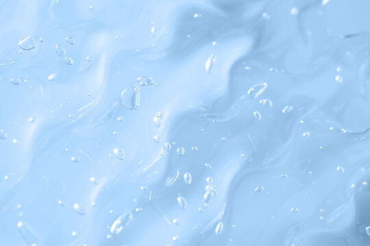 Light blue gel texture with droplets and smooth smear