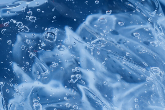 Abstract blue gel texture with bubbles and smooth smear