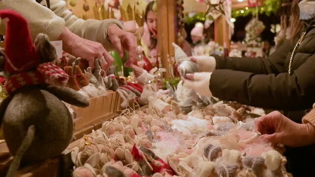 Hands Browsing Handmade Christmas Decorations at Holiday Market