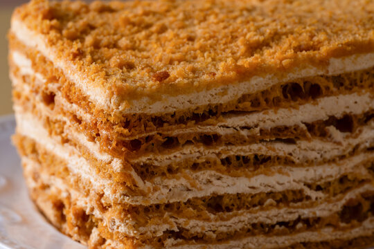 Close-up slice of layered honey cake dessert from bakery