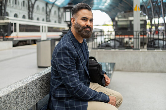 Indian businessman waiting at modern railway station platform