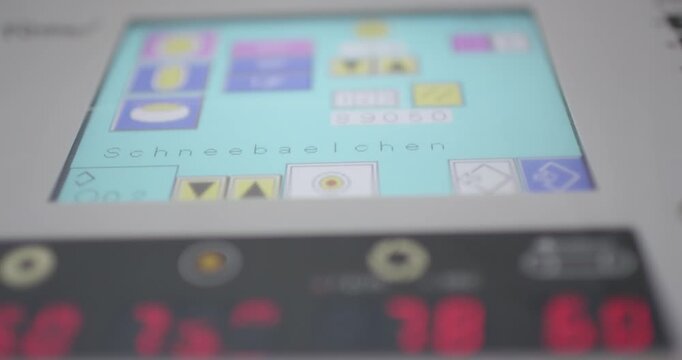 Control panel with touchscreen and red digits on a machine