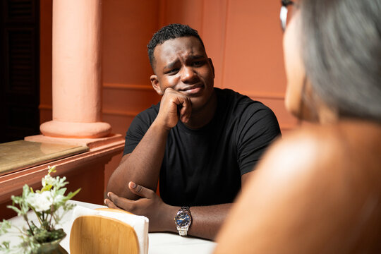 Venezuelan and Dominican couple talking in outdoor cafe