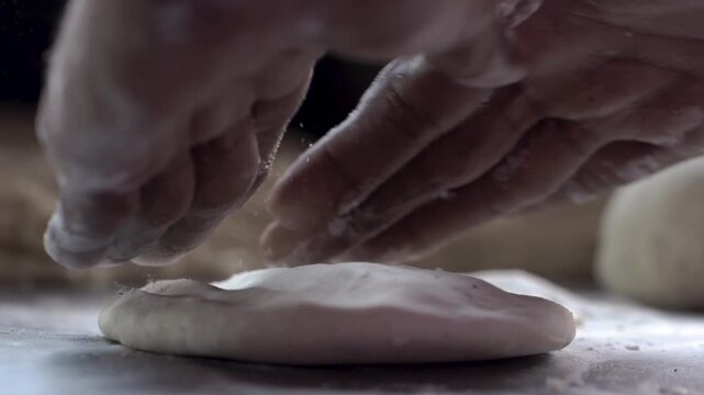 Close up shot of hands kneading fresh dough for traditional Indian flatbread preparation.