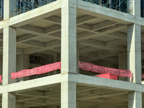 Concrete building frame with scaffolding and safety netting