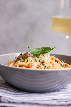 Creamy tortellini pasta with basil and parmesan garnish