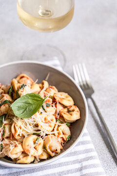 Tortellini pasta with tomato sauce, basil and parmesan