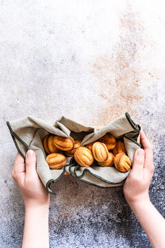 Homemade nut cookie in linen basket held in hands