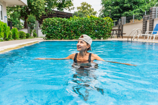 Woman enjoys a refreshing swim in summer pool