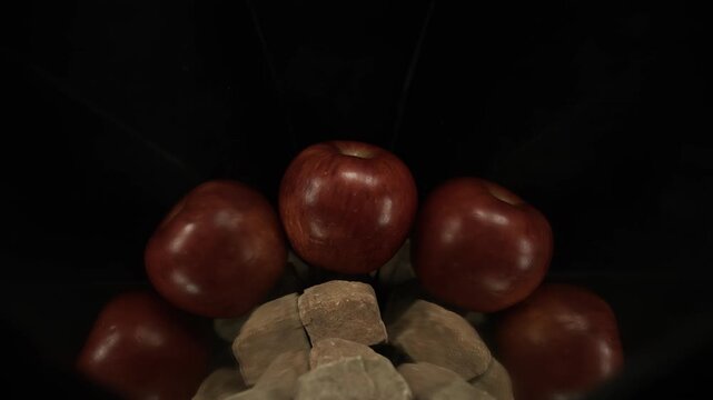 Visual air tremors and a subtle gas clap ignite momentarily around red apple in 1000fps slow motion. This refined fire stroke highlights refraction and thermal dynamics with elegant precision tremors