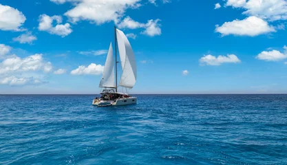 Luxury travel white sailboat yacht cruising deep sea horizon clouds sky calm water perfect idyllic summer weather. Nautical adventure freedom lifestyle background, ocean voyage wind sailing regatta © icemanphotos