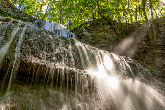 Sherman Falls, Hamilton, Ontario, showcases a stunning cascade amidst lush forest scenery.