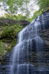 Stunning view of Tiffany Falls in Hamilton, Ontario, showcasing cascading water and lush greenery. © John