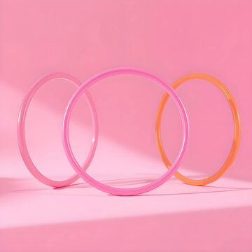Three colorful plastic hoops on pink background
