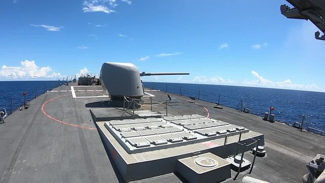 USS Milius (DDG-69), an Arleigh Burke-class guided-missile destroyer, fires its Mark 45 5-inch naval gun during a live-fire exercise at sea, showcasing modern U.S. Navy operations and readiness.
