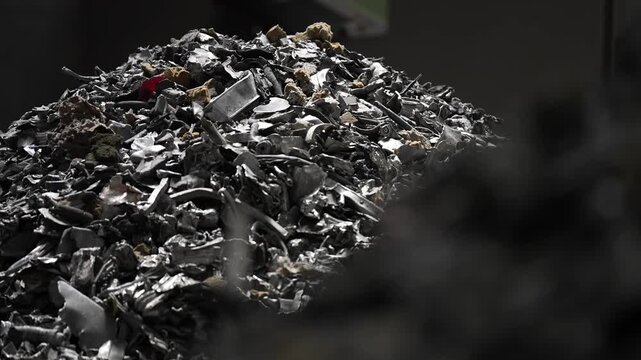 Various scrap metal and electronic waste including aluminum and circuit boards at a recycling facility