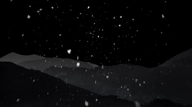 Snow is falling against the backdrop of mountains and a black background