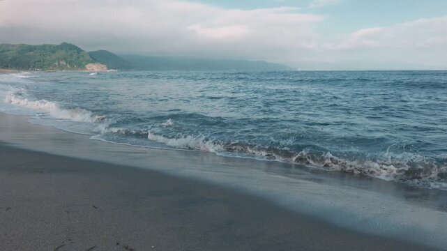 Powerful waves crashing onto a sandy beach