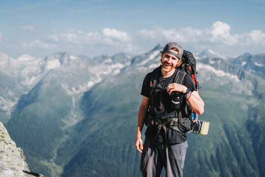 Happy hiker with camera in Bernese Alps, Switzerland