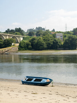 Beached Rowboat on Tranquil River