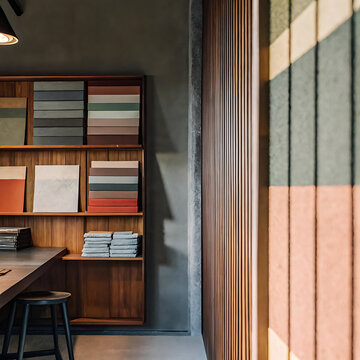 Architectural interior photograph of a tile showroom with sample displays and wooden shelving tiles samples