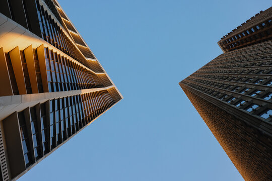 View of Two Tall Buildings Reaching Toward the Sky at Dusk