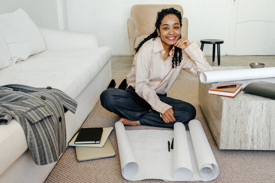 Creative Entrepreneur Reviewing Design Plans and Taking Break