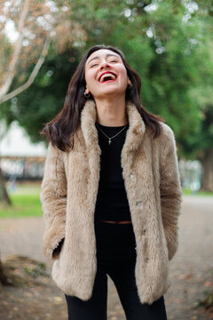 Young woman laughing with tilted head