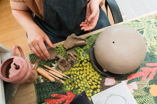 Clay Artist Works on Pottery at a Home Studio in the Afternoon