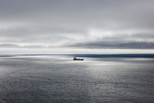 Cargo Ship on Cloudy Ocean