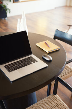 Laptop with blank screen on a table
