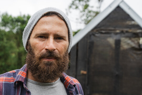 Adult male model with beard wearing beanie and flannel shirt