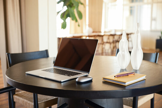 Laptop with blank screen on a table