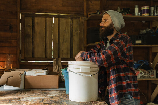 Artisan contemplating future projects in a rustic workshop