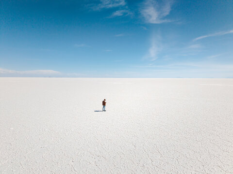 Solitary figure surrounded by the vast Uyuni Salt Flats