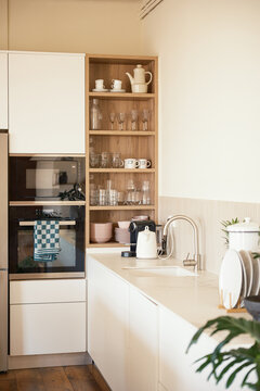 Modern white kitchen with cookware