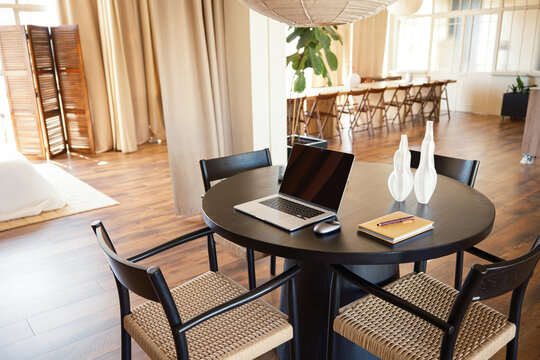 Laptop with blank screen on a table