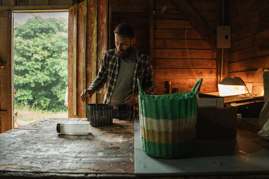 Producer processing crops in rustic shed
