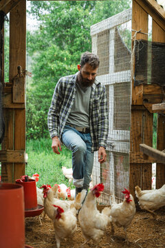 Farmer entering chicken coop working in agriculture