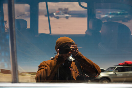Self portrait reflected in expedition vehicle in Bolivia