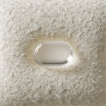 Oval metallic object set against a textured fibrous background neutral color palette abstract beige close up