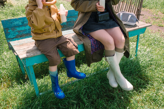 Mother and son sharing a snack on a park bench, cropped detail