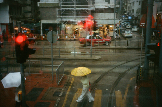 Rainy City Street Captures Vibrant Life and Color in Motion